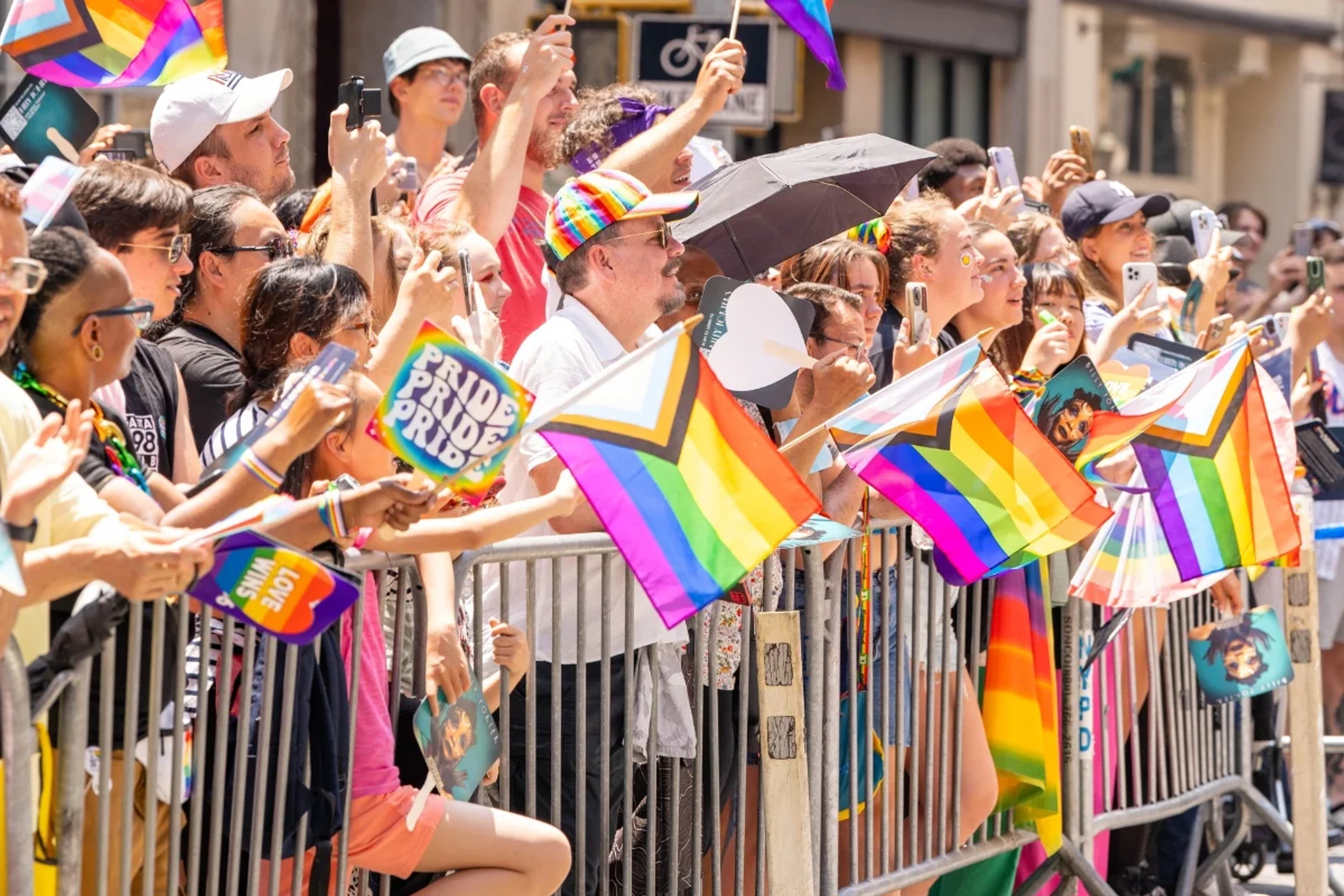 Spectators at the New York Pride Parade waving flags
