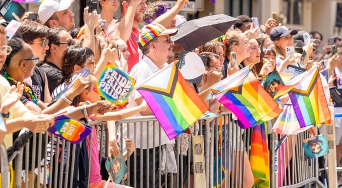 Spectators at the New York Pride Parade waving flags