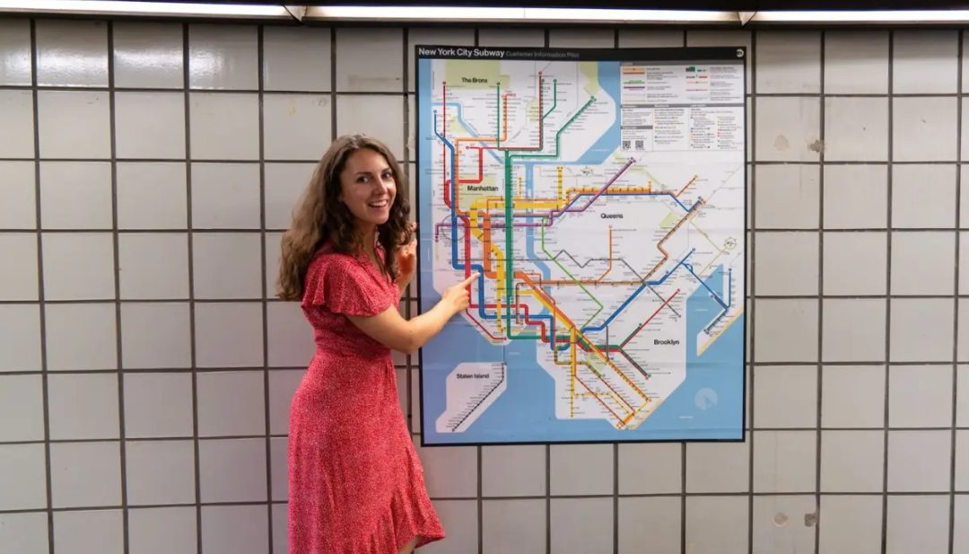 Maureen pointing to a subway map
