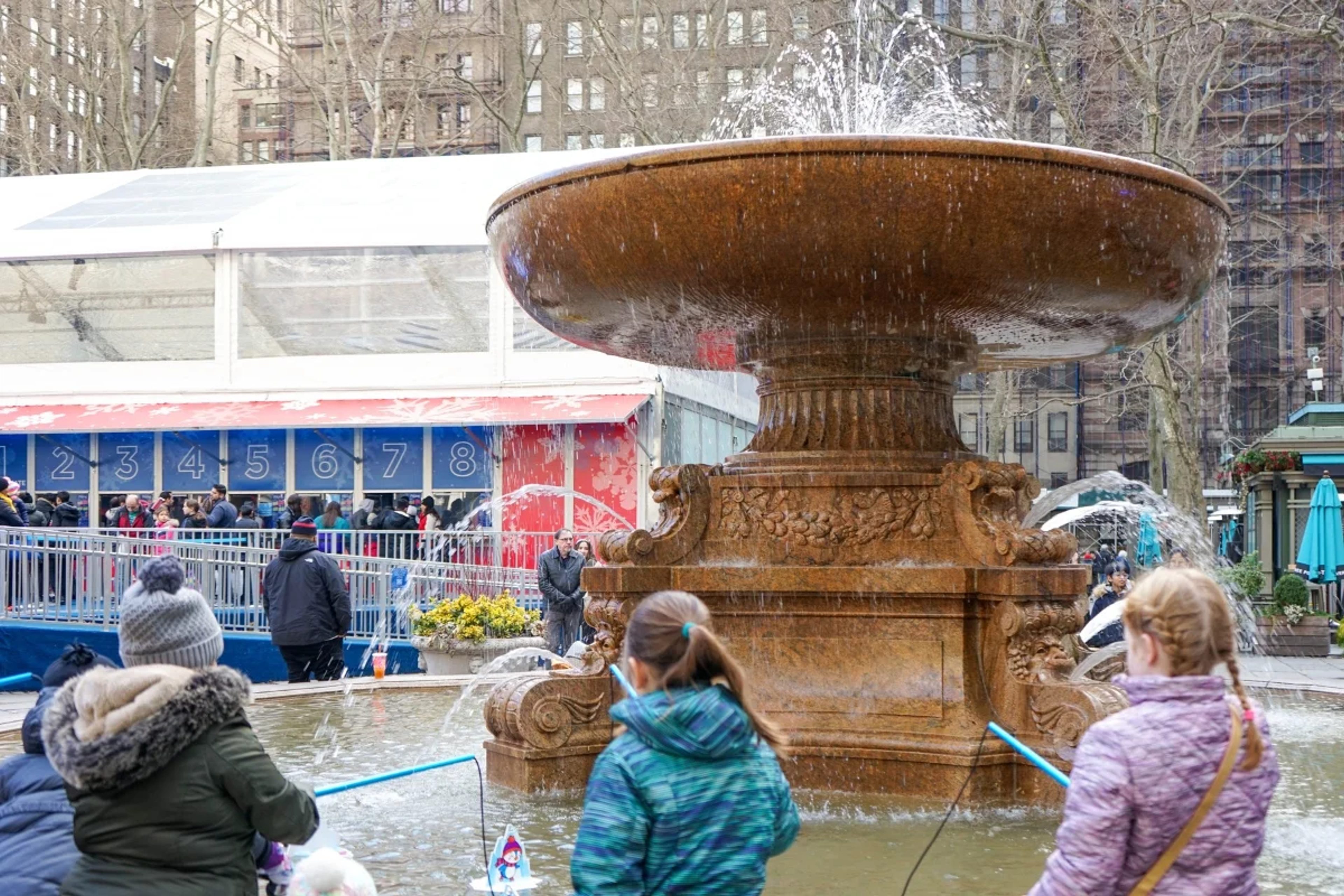 Kids playing fishing the fountain in Bryant Park