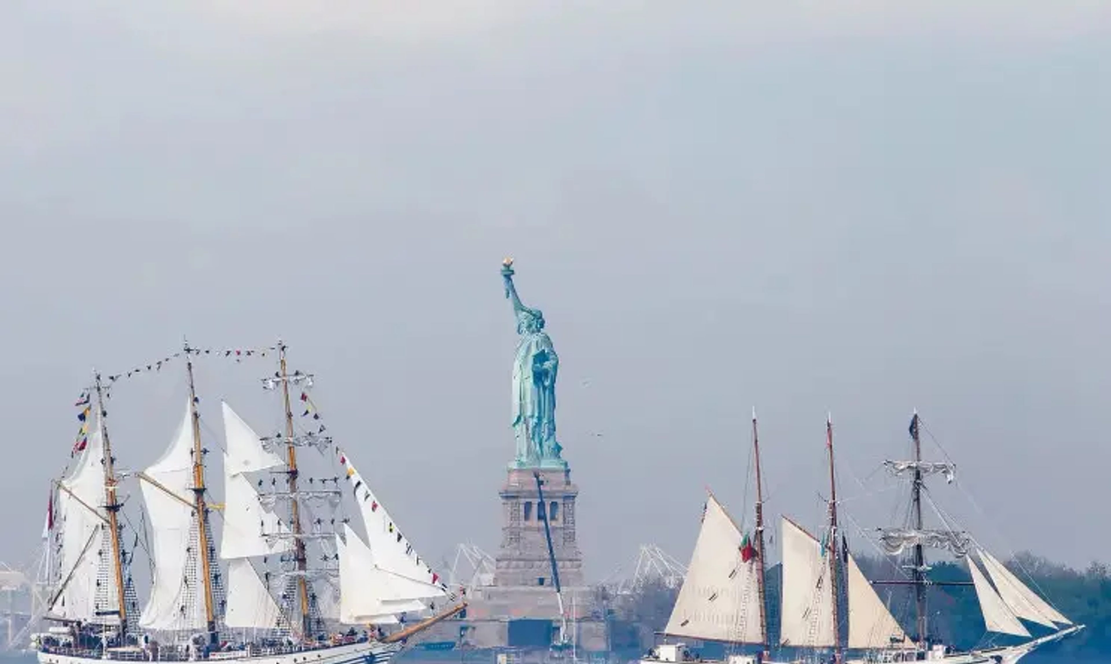 Sailboats in front of the Statue of Liberty
