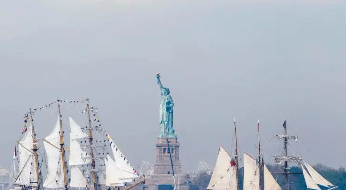 Sailboats in front of the Statue of Liberty