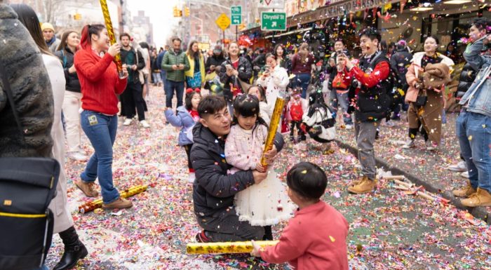 Street celebration on Mott Street in New York with confetti poppers