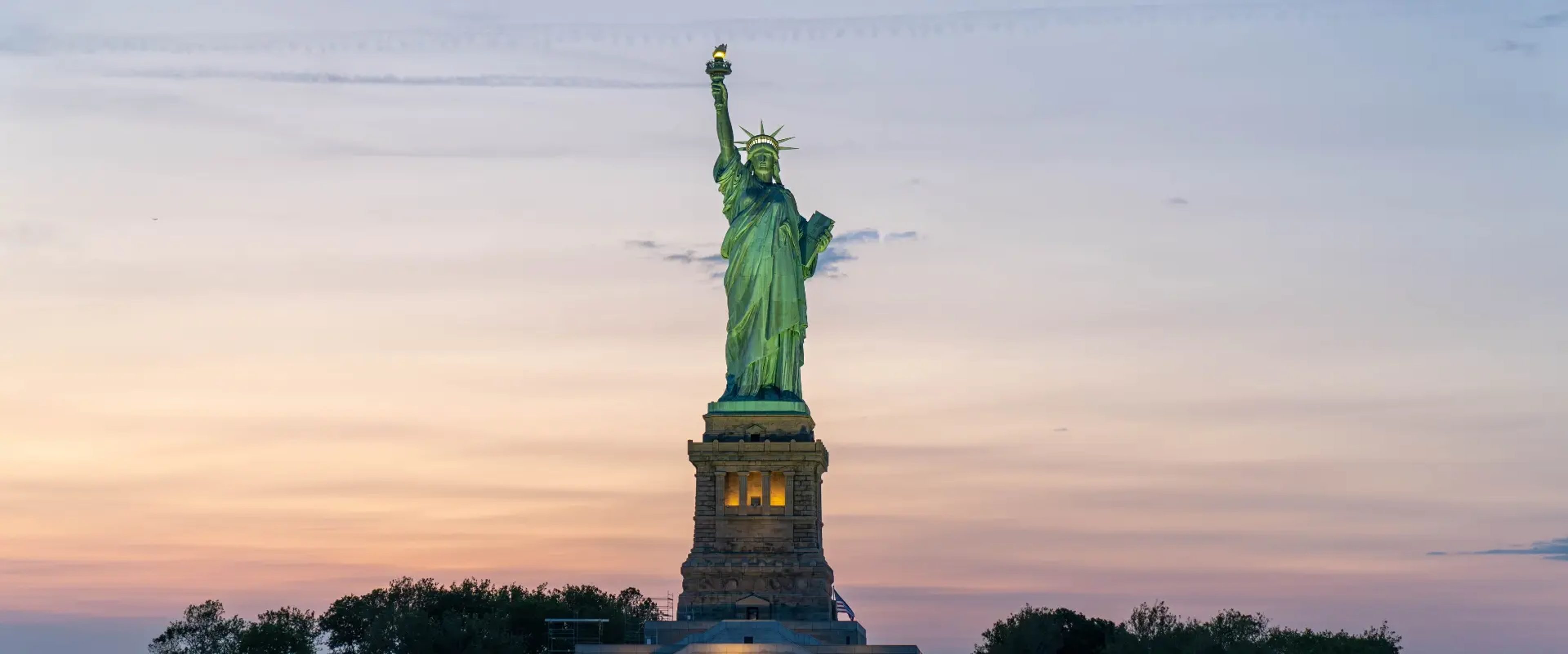 Statue of Liberty during sunset seen from a boat