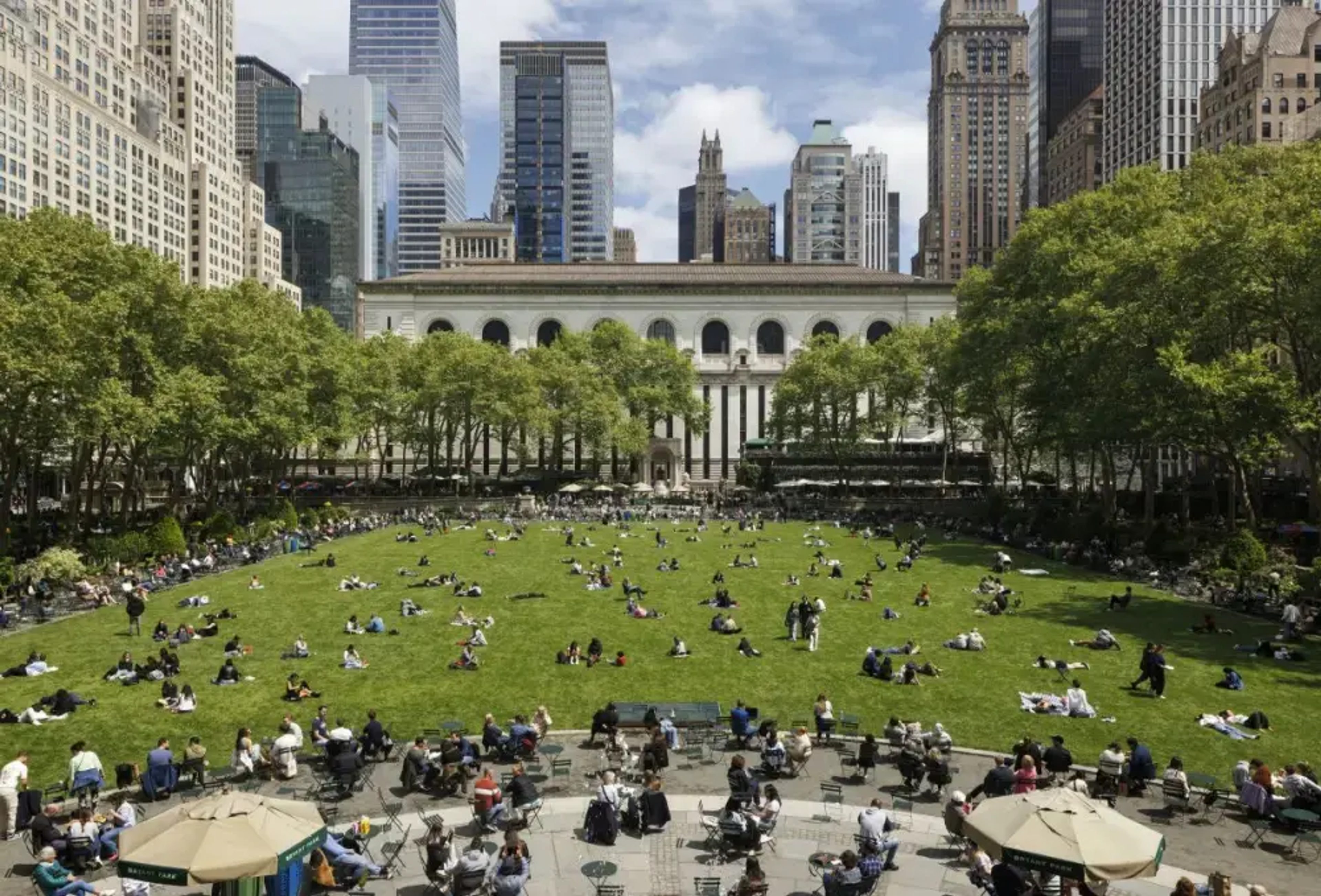 People enjoying the green lawn in Bryant Park