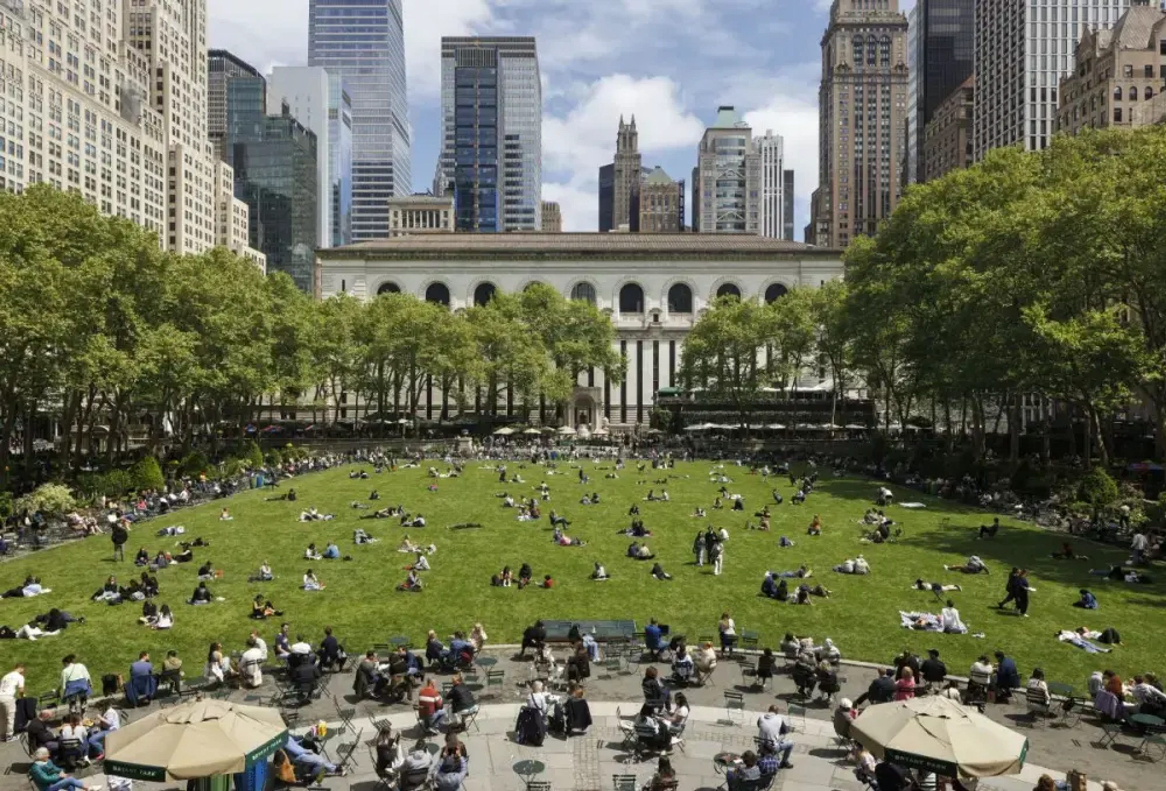 People enjoying the green lawn in Bryant Park