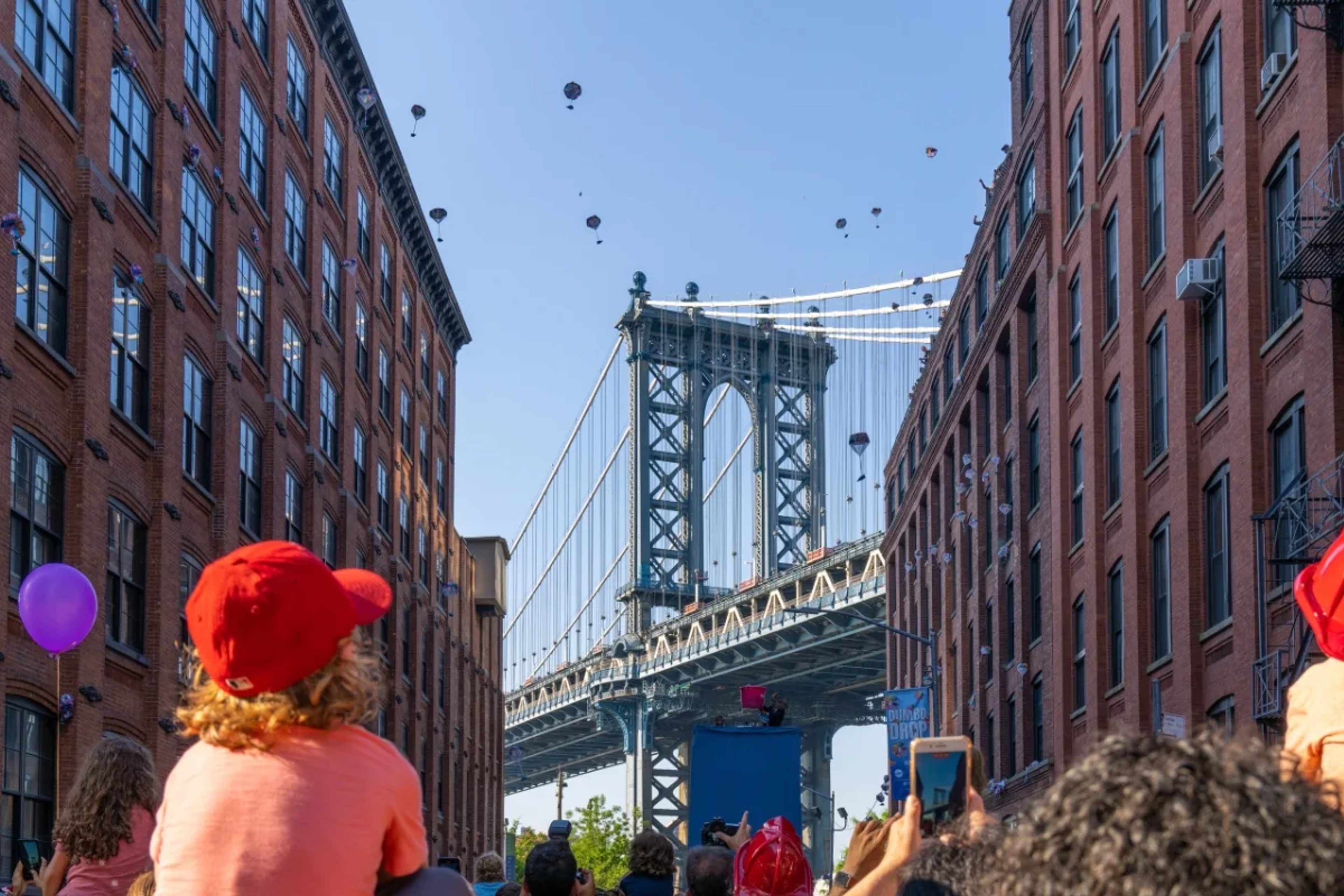 Elephants parachute onto the street in DUMBO with view of the Manhattan Bridge