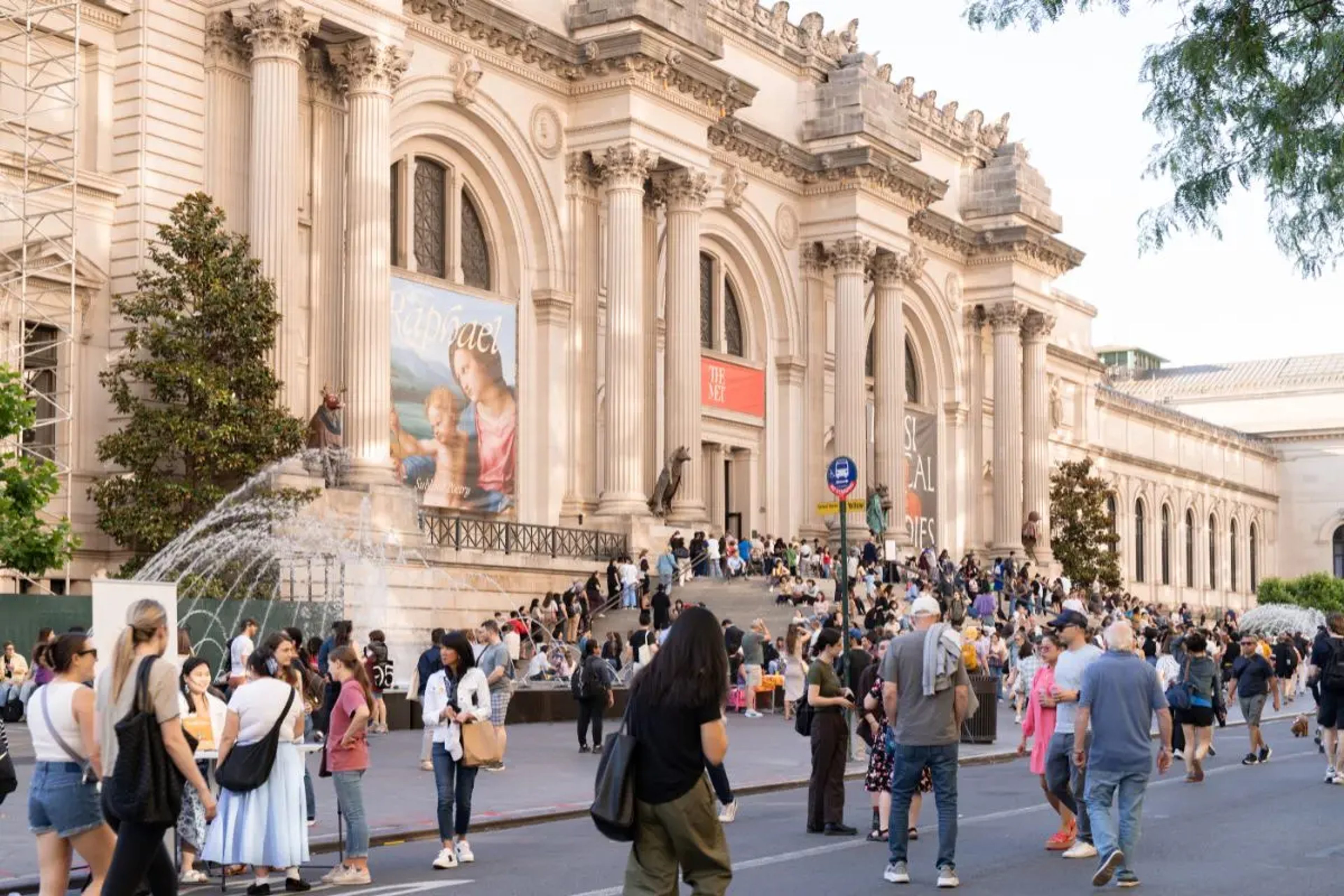 People walking on Fifth Avenue in front of the Met Museum