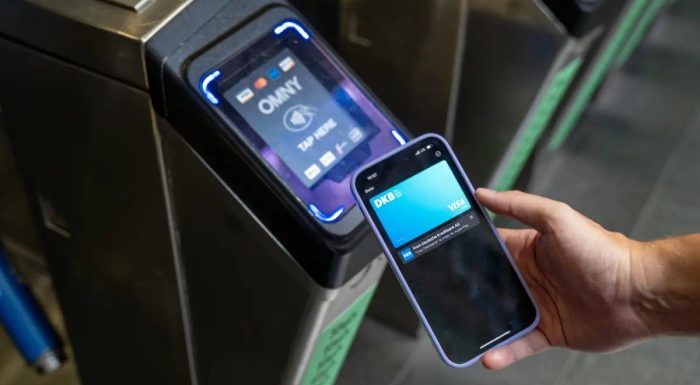 Phone with credit card at the subway turnstile