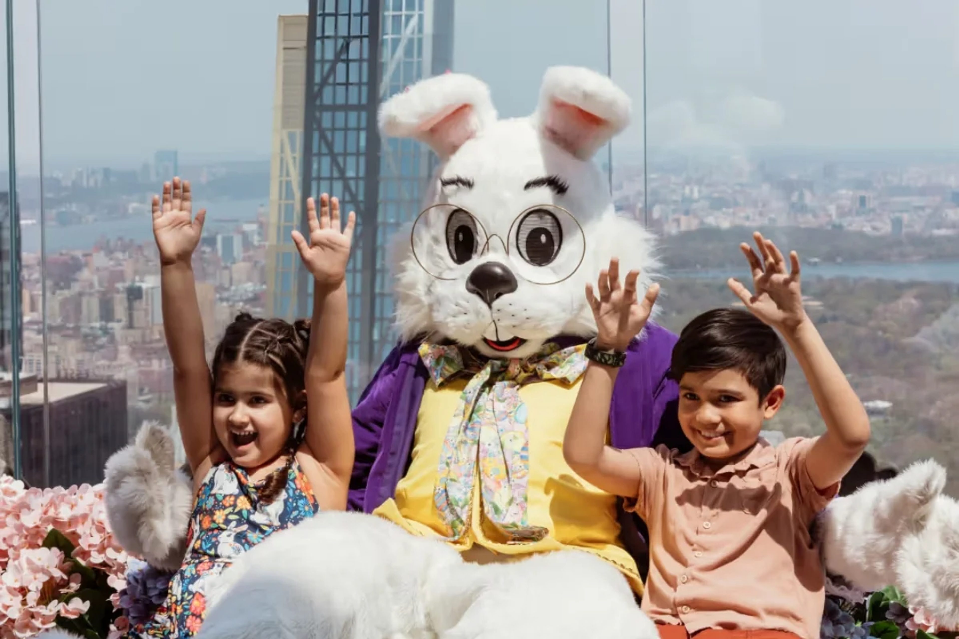Easter Bunny and two kids sit on the Beam at Top of the Rock