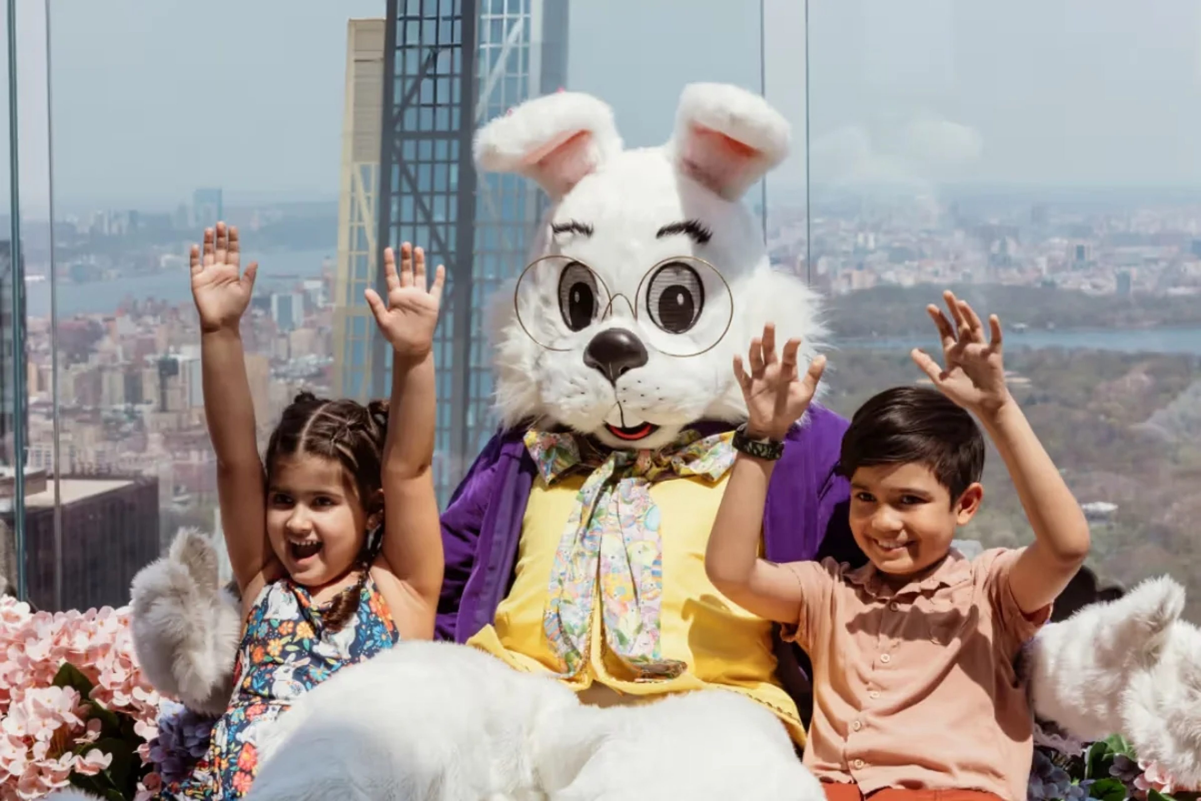 Easter Bunny and two kids sit on the Beam at Top of the Rock