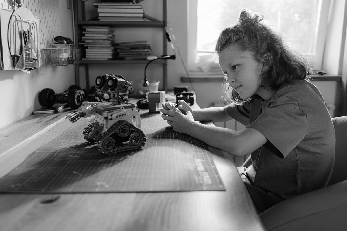 Kid playing with robot