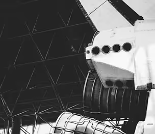 Space shuttle engine system inside aerospace assembly hangar highlighting advanced propulsion technology