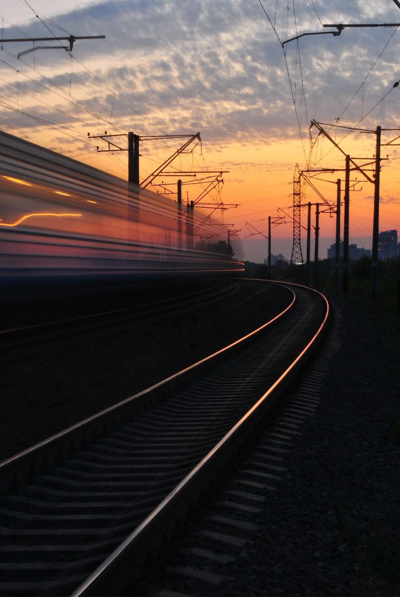 Rapidly moving Train with Sunset in the background