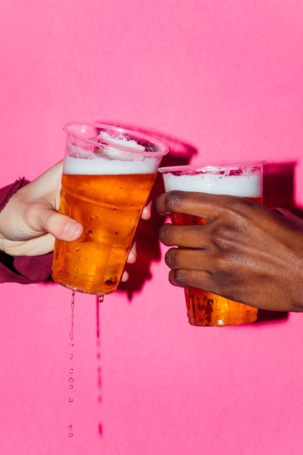 Closeup of two raised beer glasses