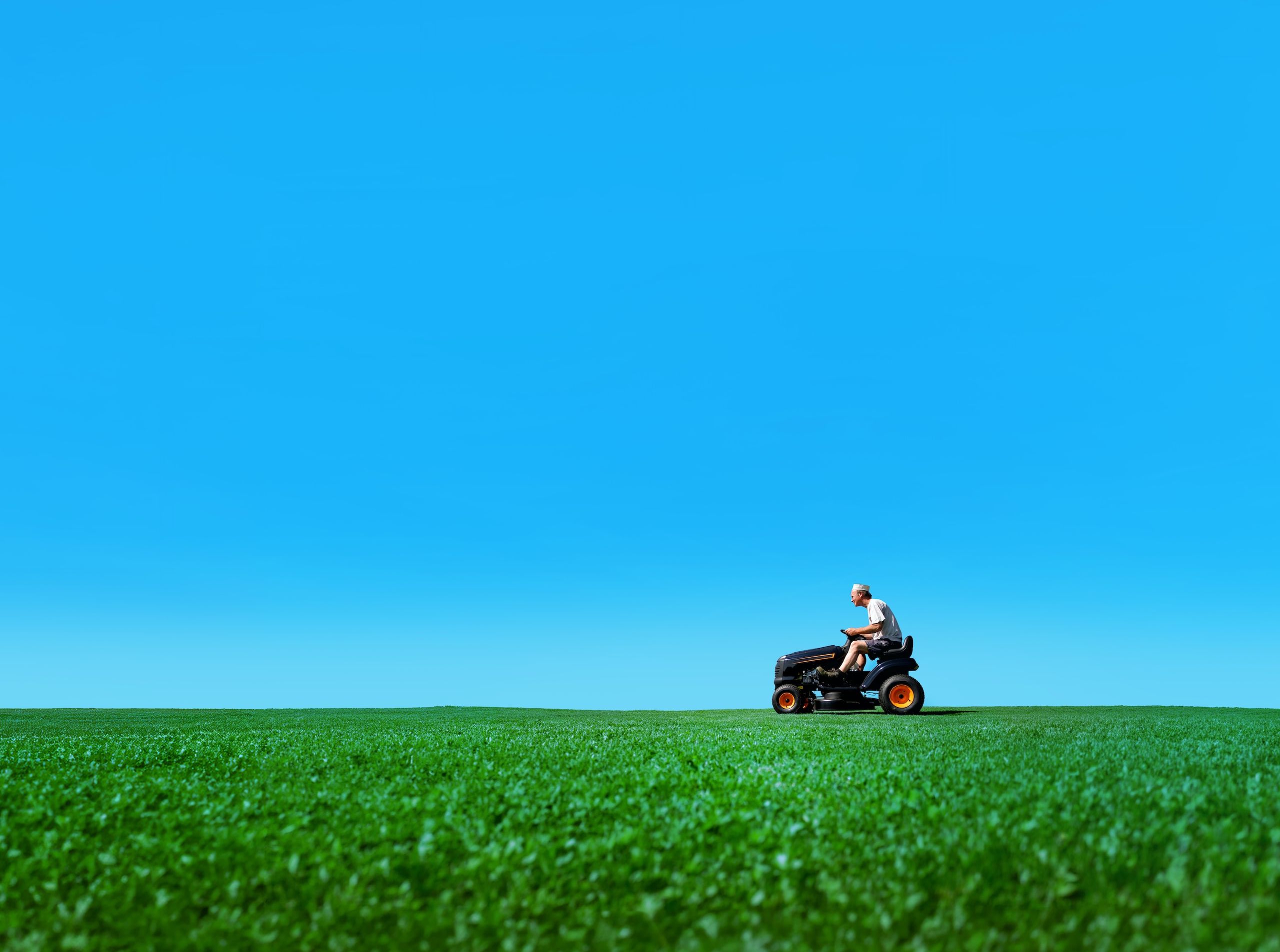 Lawnmower Man riding across a green field
