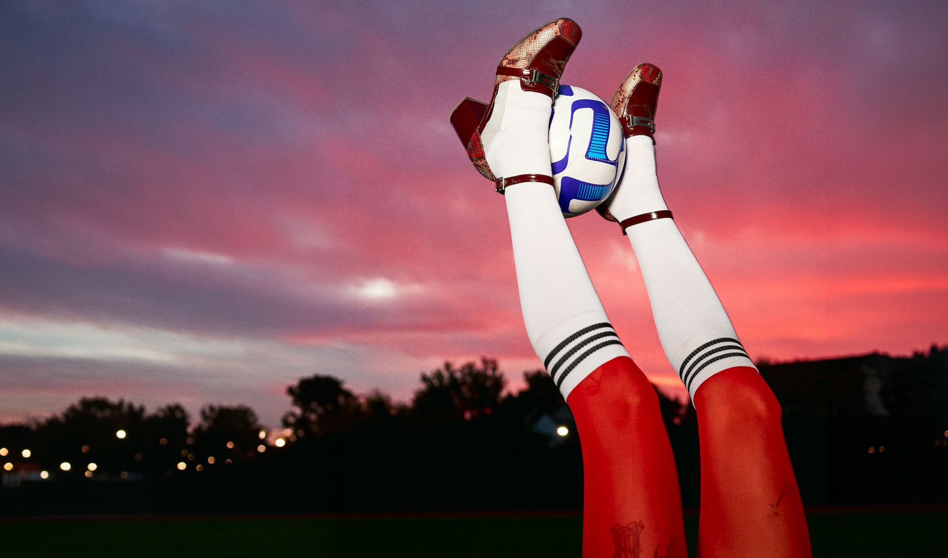 Soccer ball balanced between raised feet