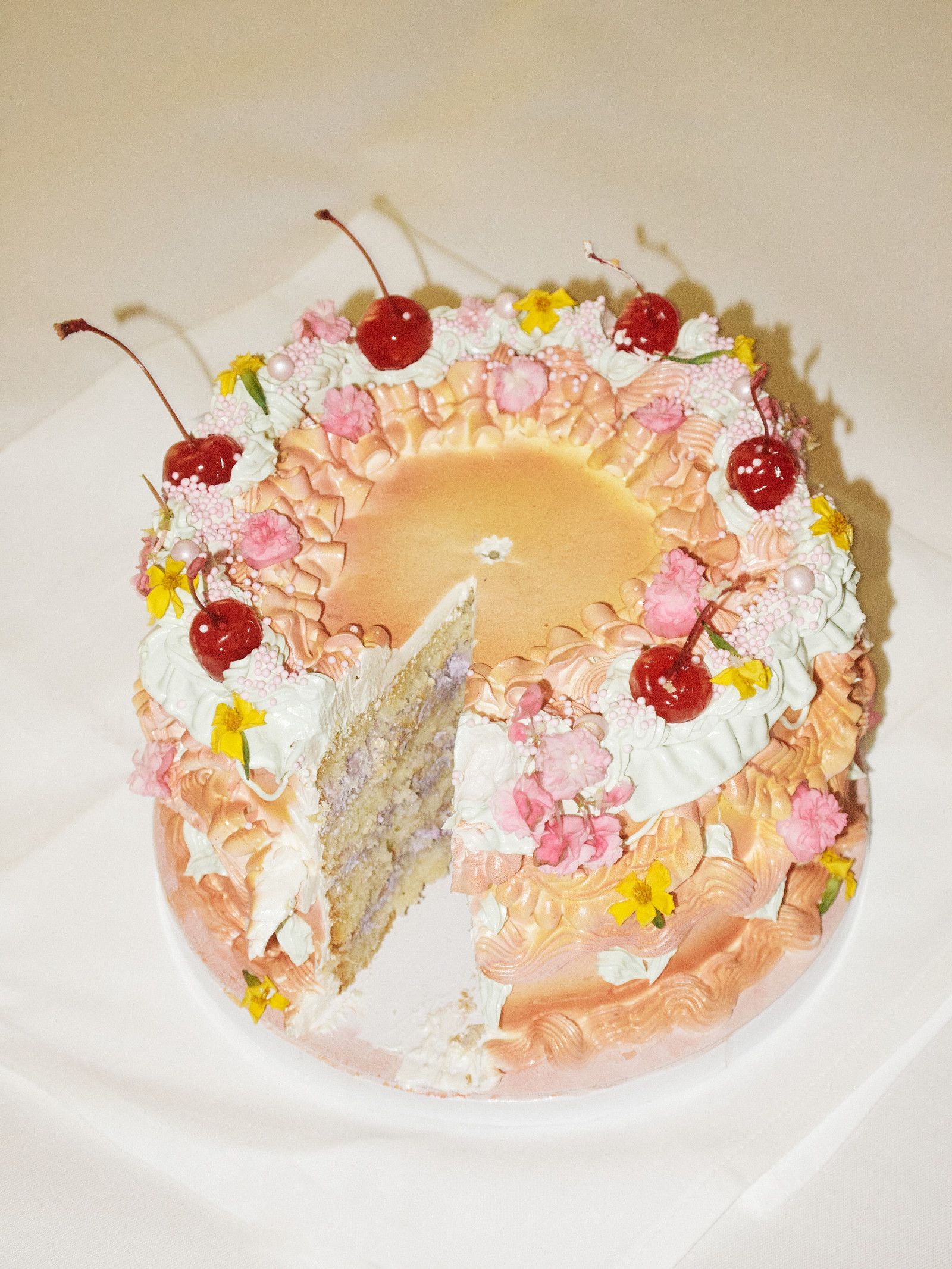 Decorated cake with cherries and flowers