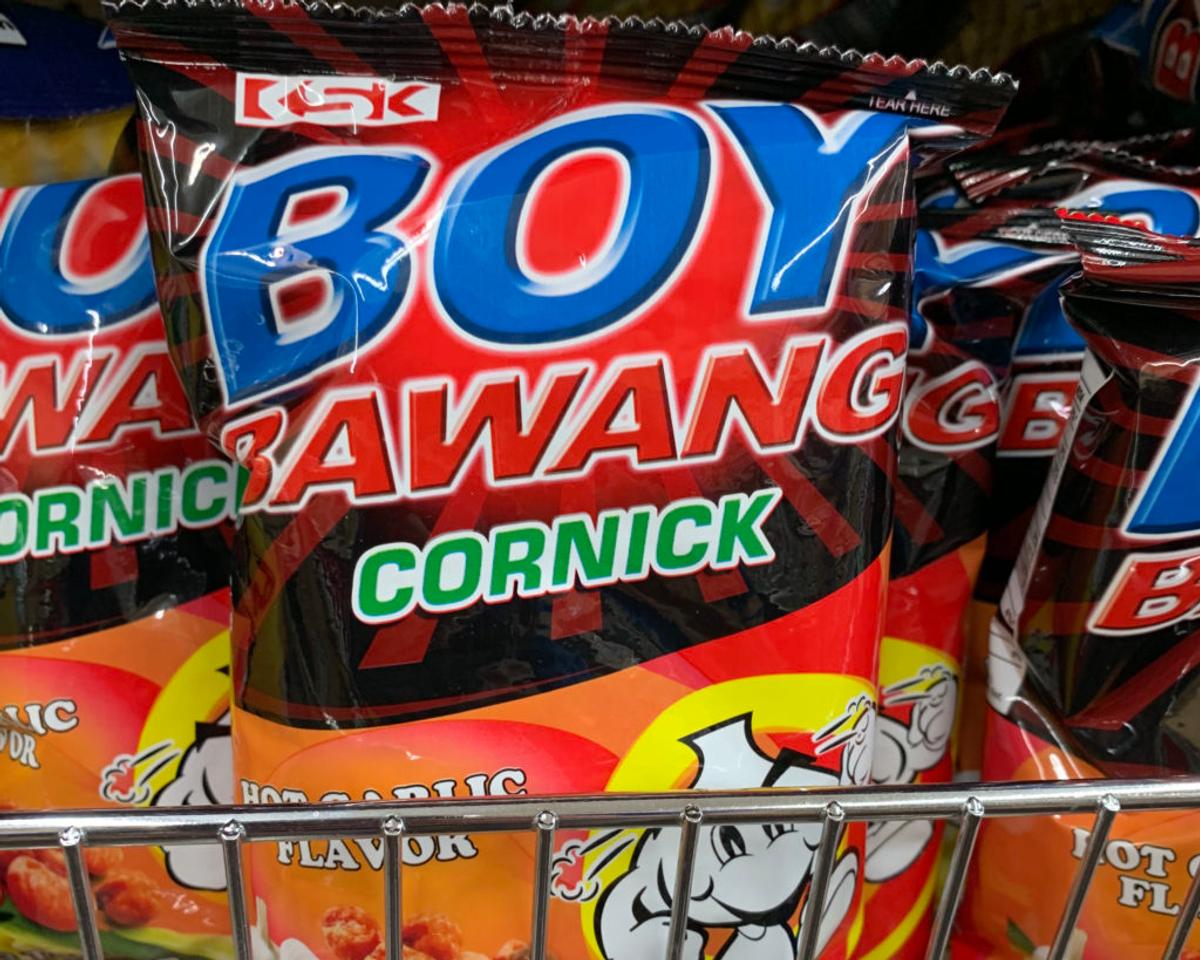 Packets of "Boy Bawang Cornick" in Hot Garlic Flavor on a store shelf.