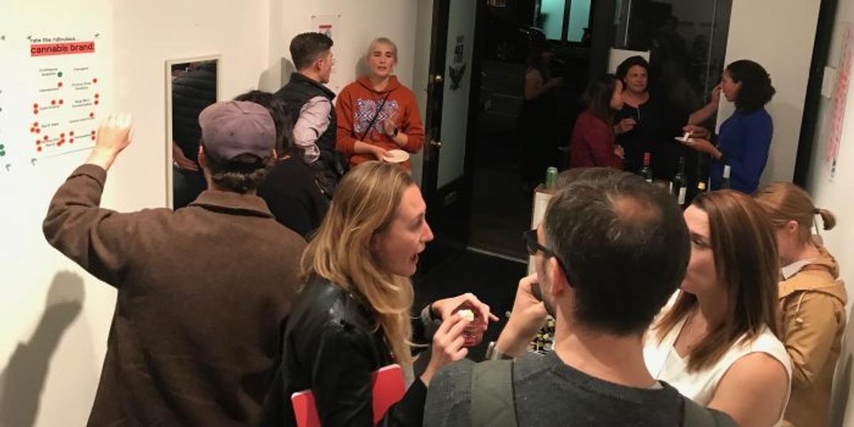 Guests at a crowded party sticker a wall chart headed "Rate this ridiculous cannabis brand."