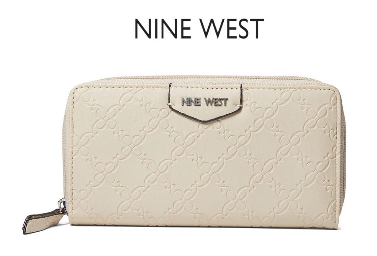 A cream embossed zip wallet under the "Nine West" logo.