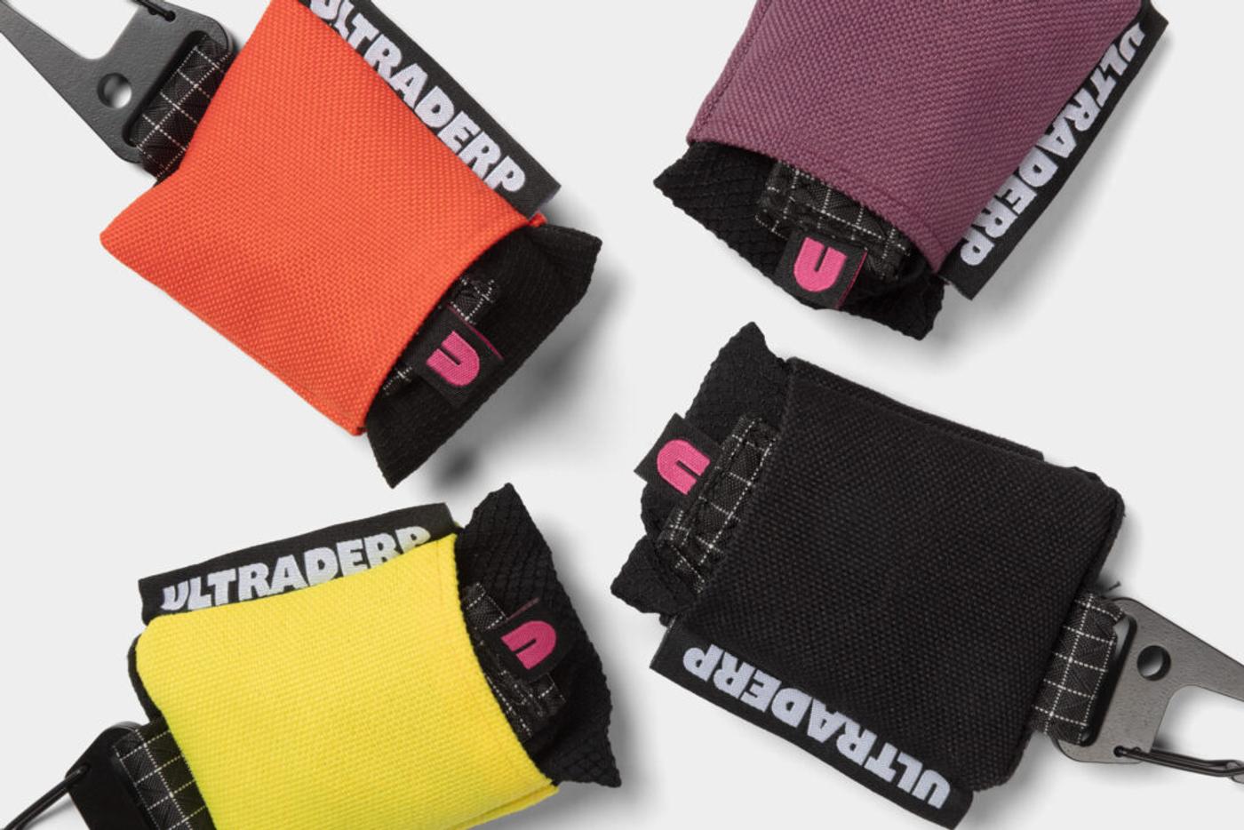 Ultraderp pouches in orange, purple, yellow and black, the name printed on their webbing