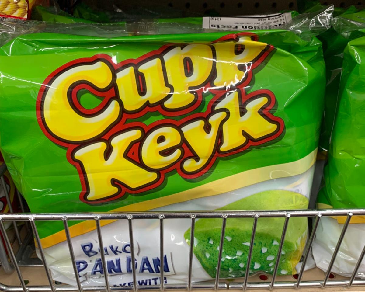 Green package of "Cupp Keyk" Buko Pandan snack cakes on a store shelf.
