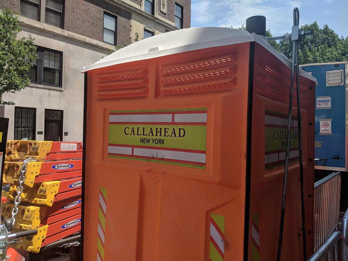 Orange portable toilet branded "Callahead New York."