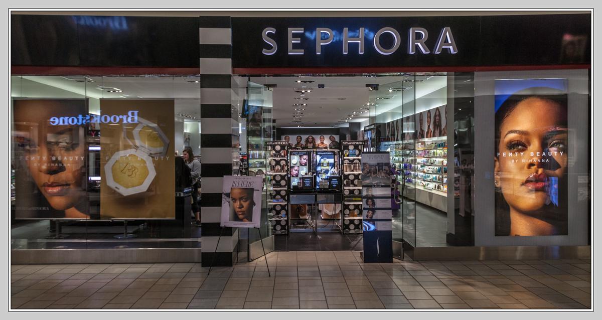 A mall Sephora storefront with big Fenty Beauty by Rihanna posters in the windows.