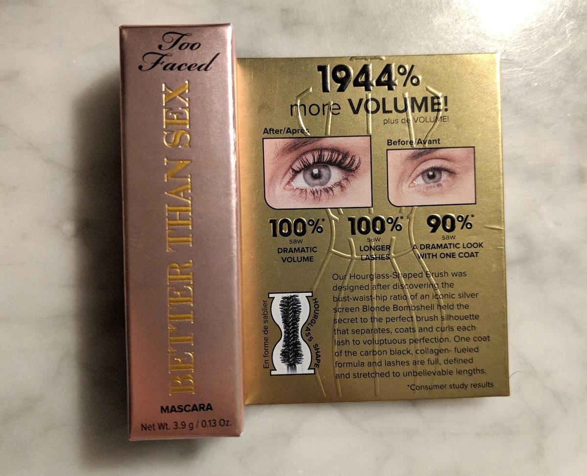 Too Faced "Better Than Sex" mascara box beside gold packaging claiming "1944% more VOLUME!"