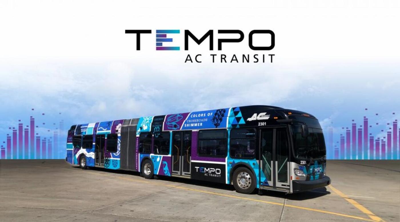 A Tempo bus in AC Transit's blue and purple livery, the wordmark above it