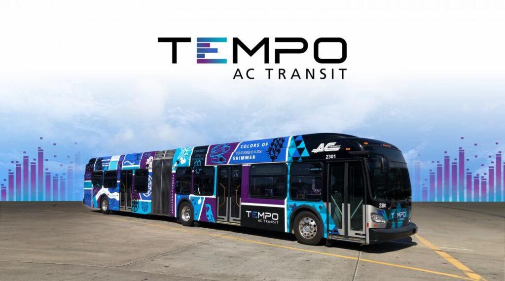 A Tempo bus in AC Transit's blue and purple livery, the wordmark above it