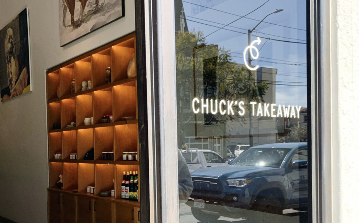 "Chuck's Takeaway" lettered on the shop window, shelves of jars and bottles inside