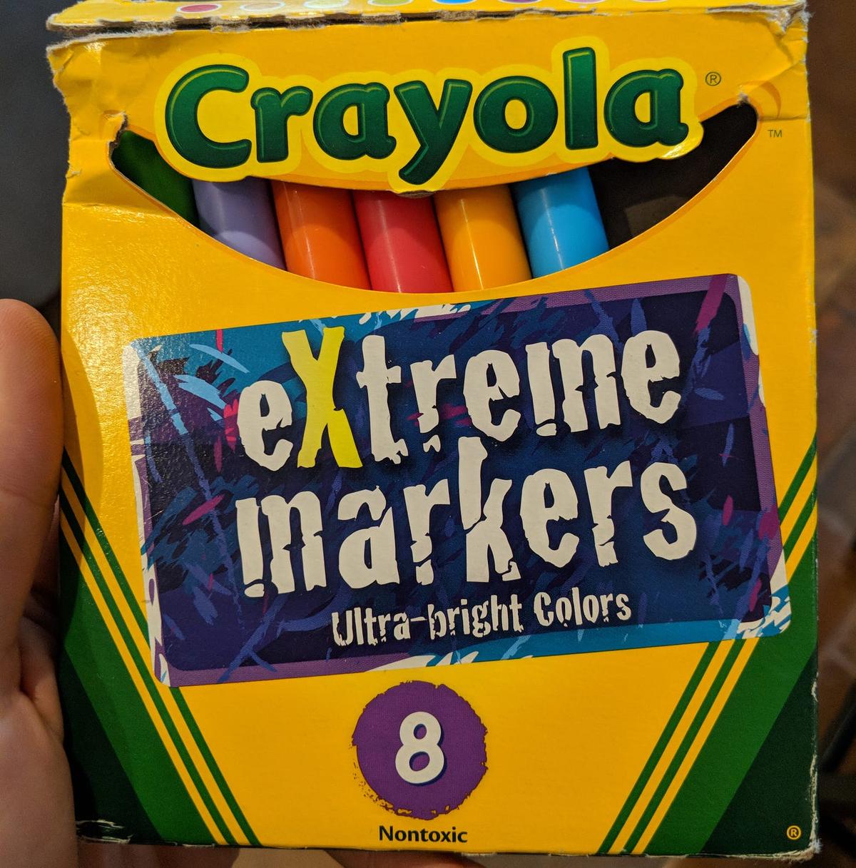 A yellow Crayola box of 8 markers labeled "eXtreme markers: Ultra-bright Colors."