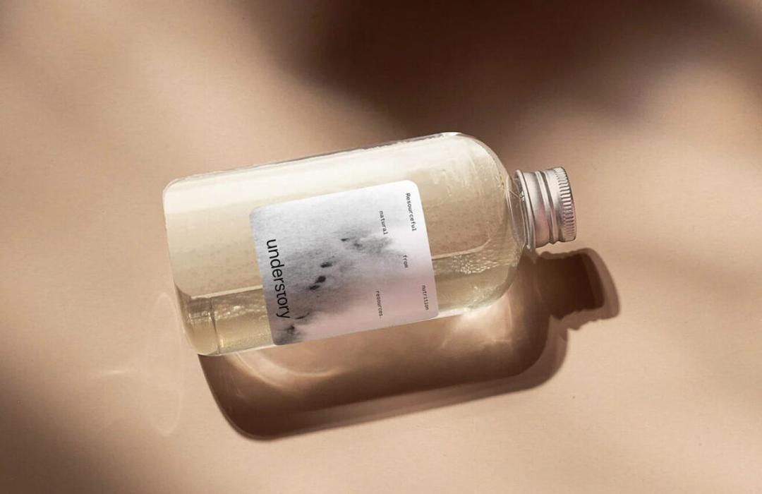 An Understory bottle on its side, its label carrying a soft photographic mark