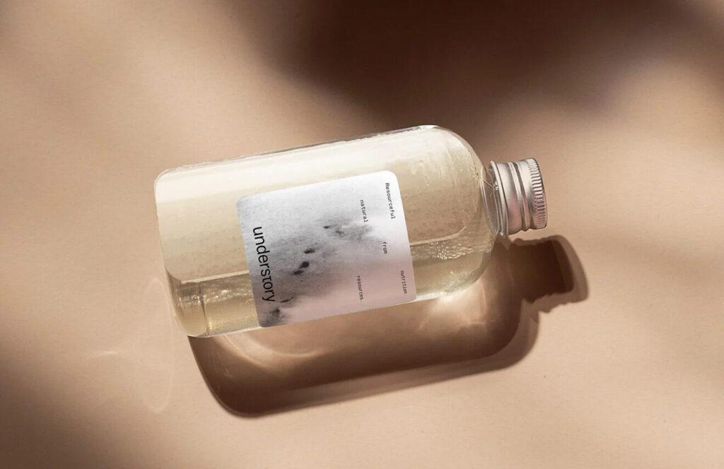 An Understory bottle on its side, its label carrying a soft photographic mark