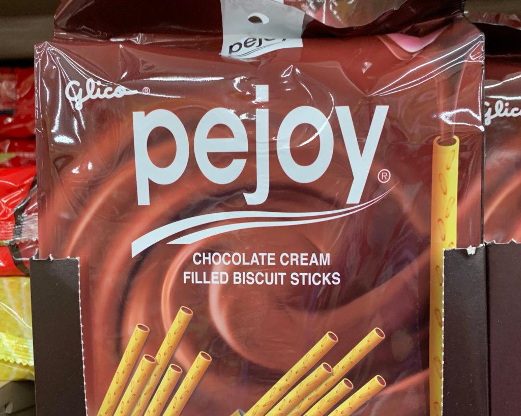 Glico "Pejoy" pack: "chocolate cream filled biscuit sticks" on a brown wrapper.