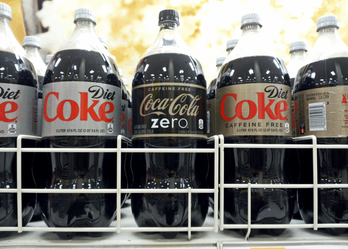 Two-liter bottles on a store shelf: "Diet Coke," some caffeine free, beside "Caffeine Free Coca-Cola Zero."