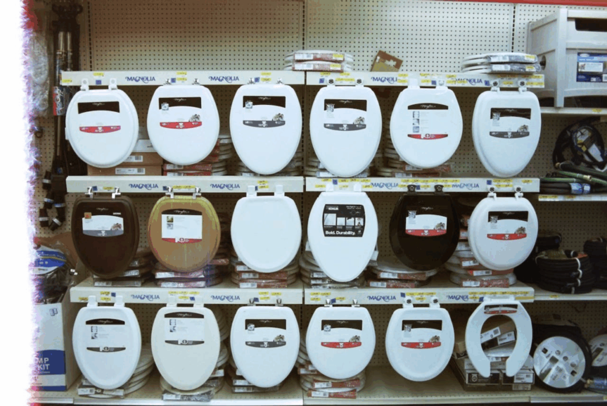 Hardware store shelves of toilet seats, each shelf edge labeled "Magnolia."