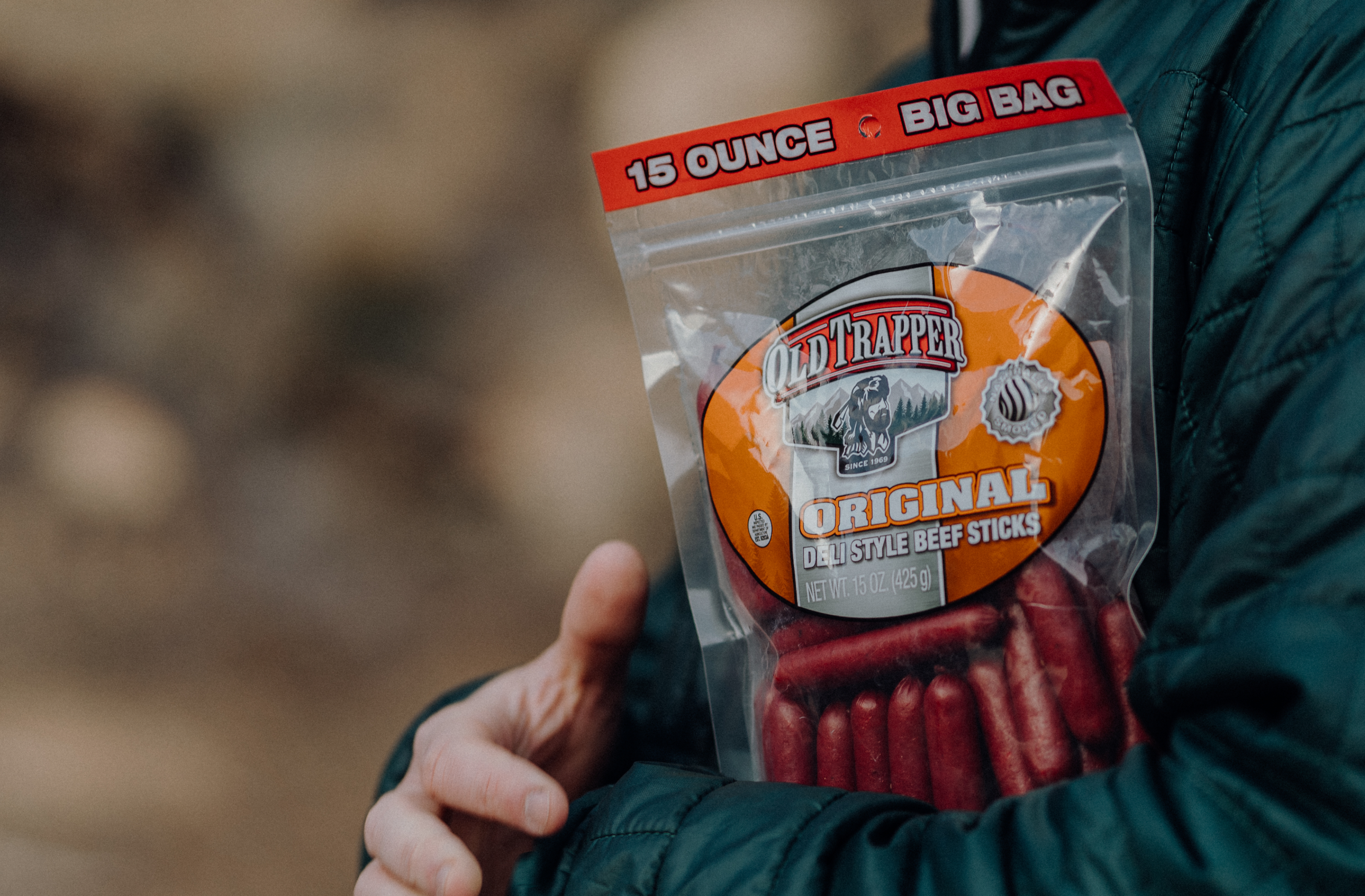 Person holding old trapper original deli style beef sticks