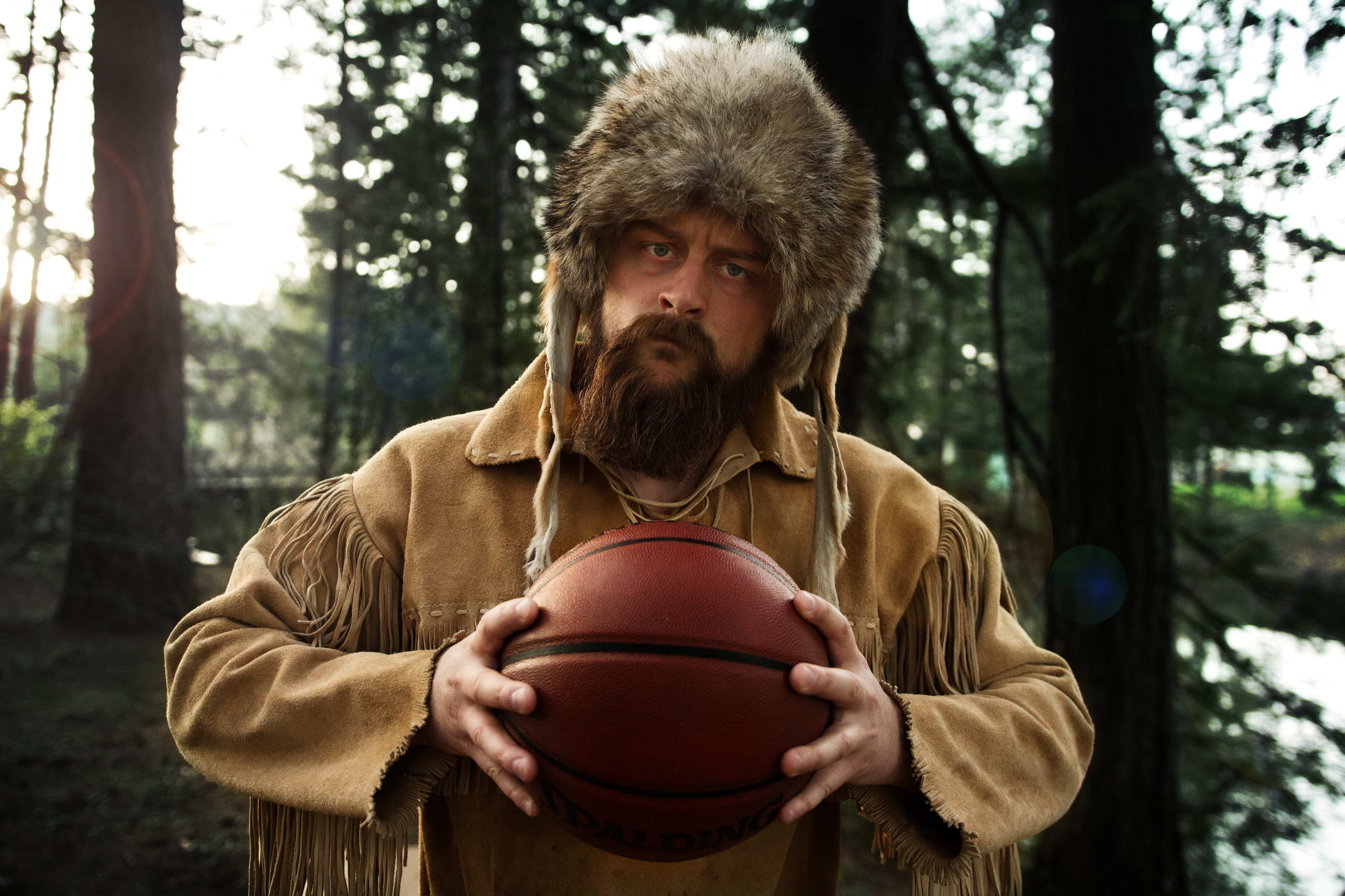 Old Trapper holding basketball