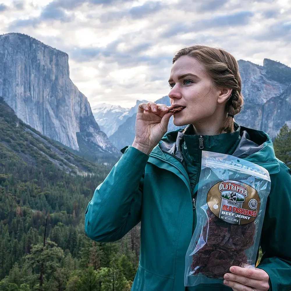 Women hiking with bag of Old Trapper's Old Fashioned Beef Jerky