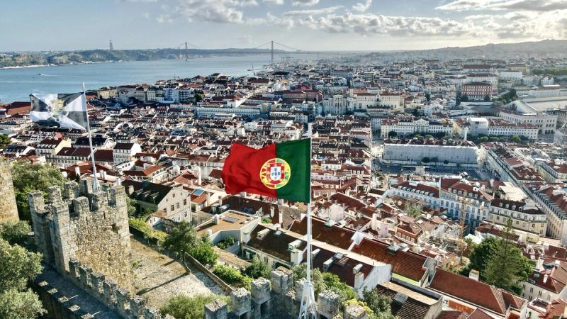 Flag of Portugal raised with the city of Lisbon in the background