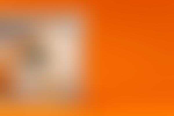 A one hundred dollar bill on an orange background