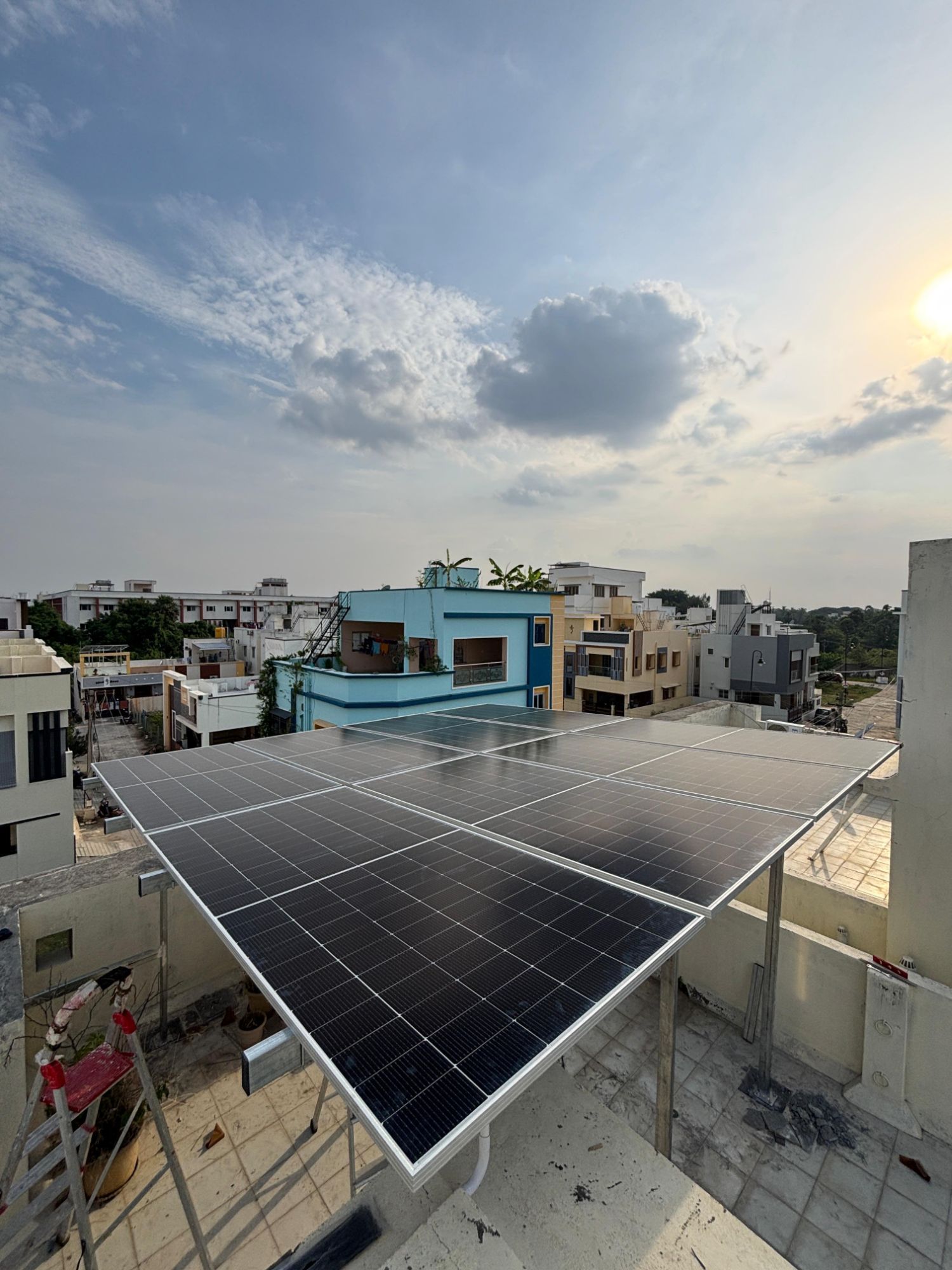 Rooftop array under a bright Madurai sky