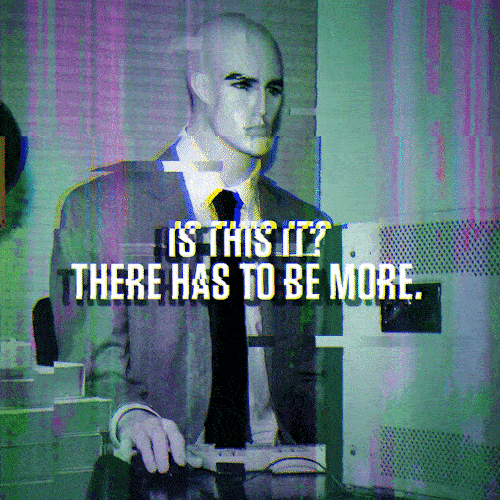 A looping animation of a mannequin robot dressed in a suit engaged with a computer. Text reads: Is this it? There has to be more.
