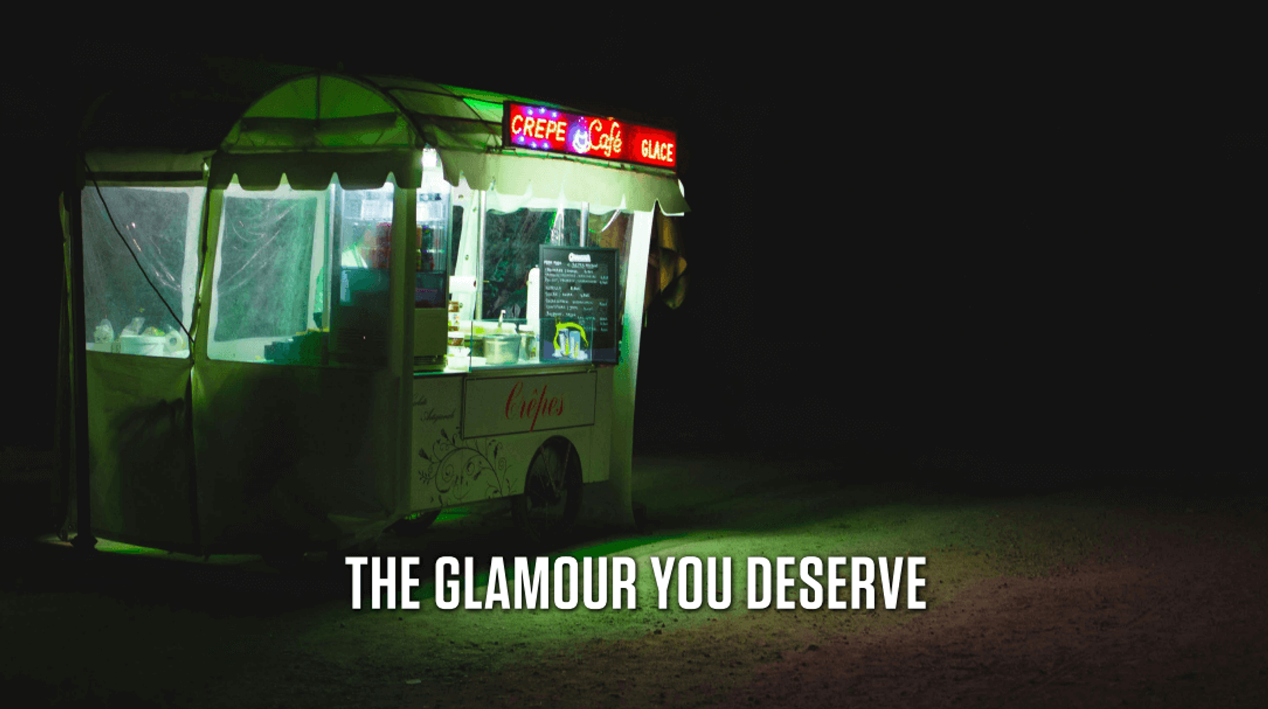 A strange food cart at night, glowing with green and red neon lights. The cart's sign reads "CREPE Café GLACE". Caption text on the graphic reads: The glamour you deserve.