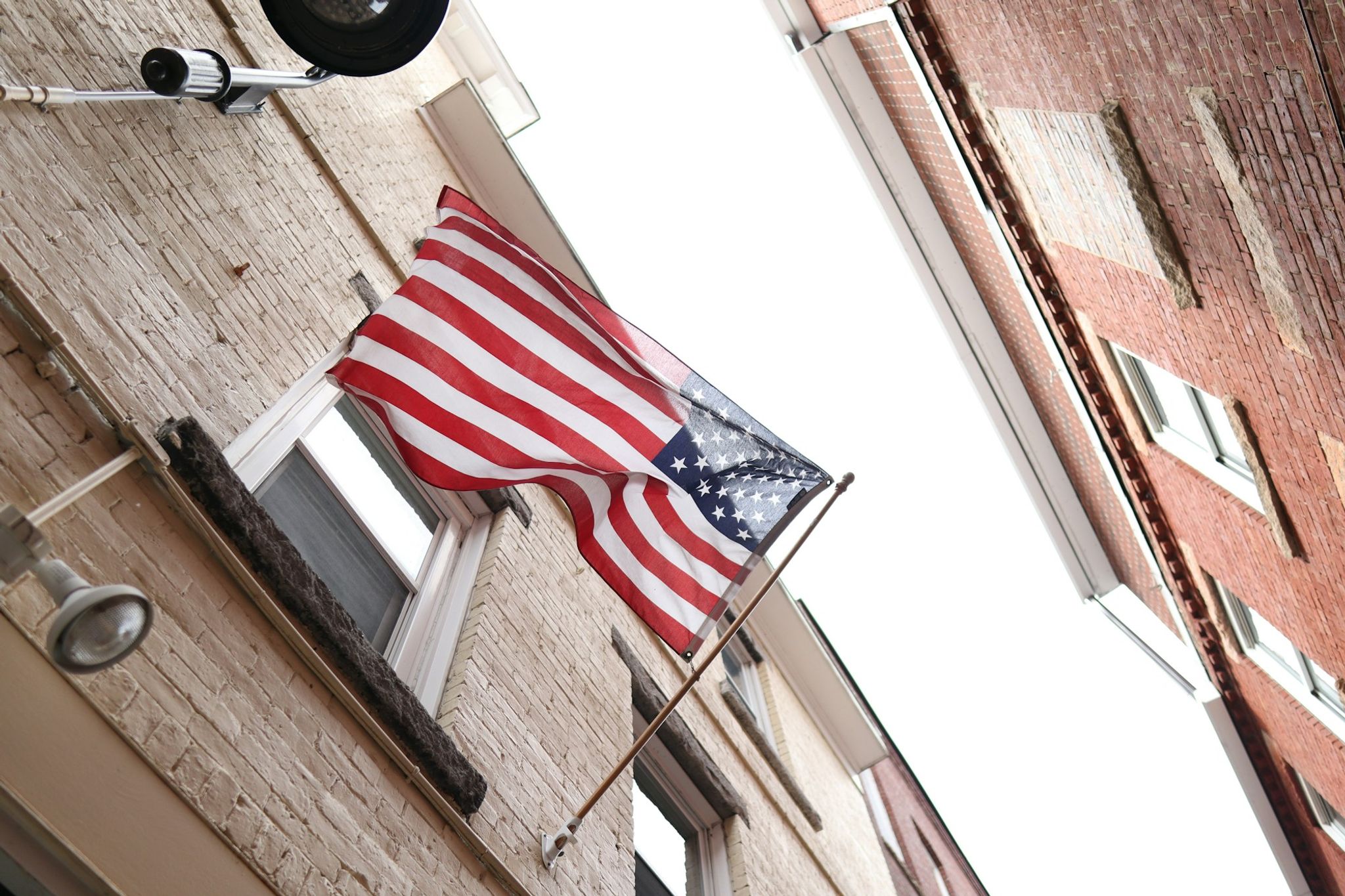 American flag on a historic brick street