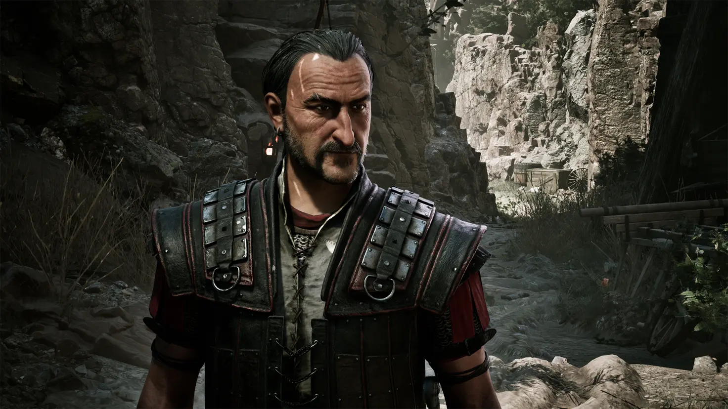 A warrior stands in leather armor in the Gothic 1 Remake. He has hair slicked back and an earring.