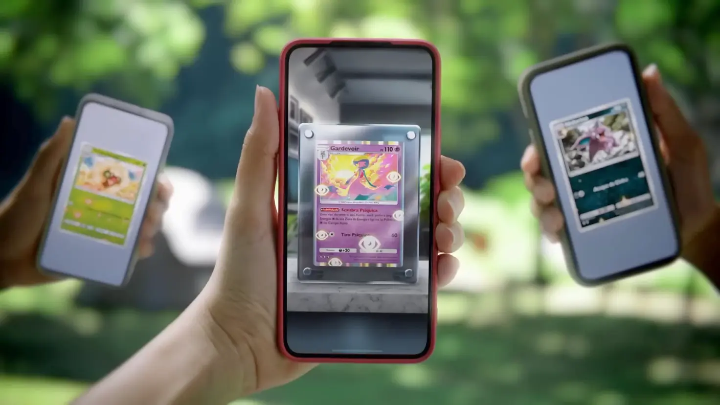 Three hands holding mobile phones displaying the Pokemon TCG Pocket video game